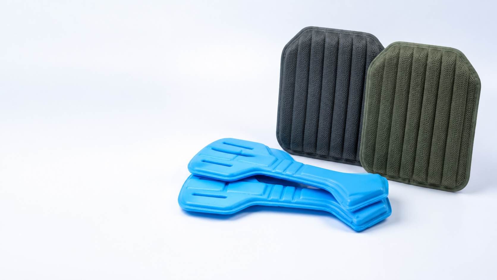 Blue thermoformed protective components with gray and olive fabric-laminated molded back pads